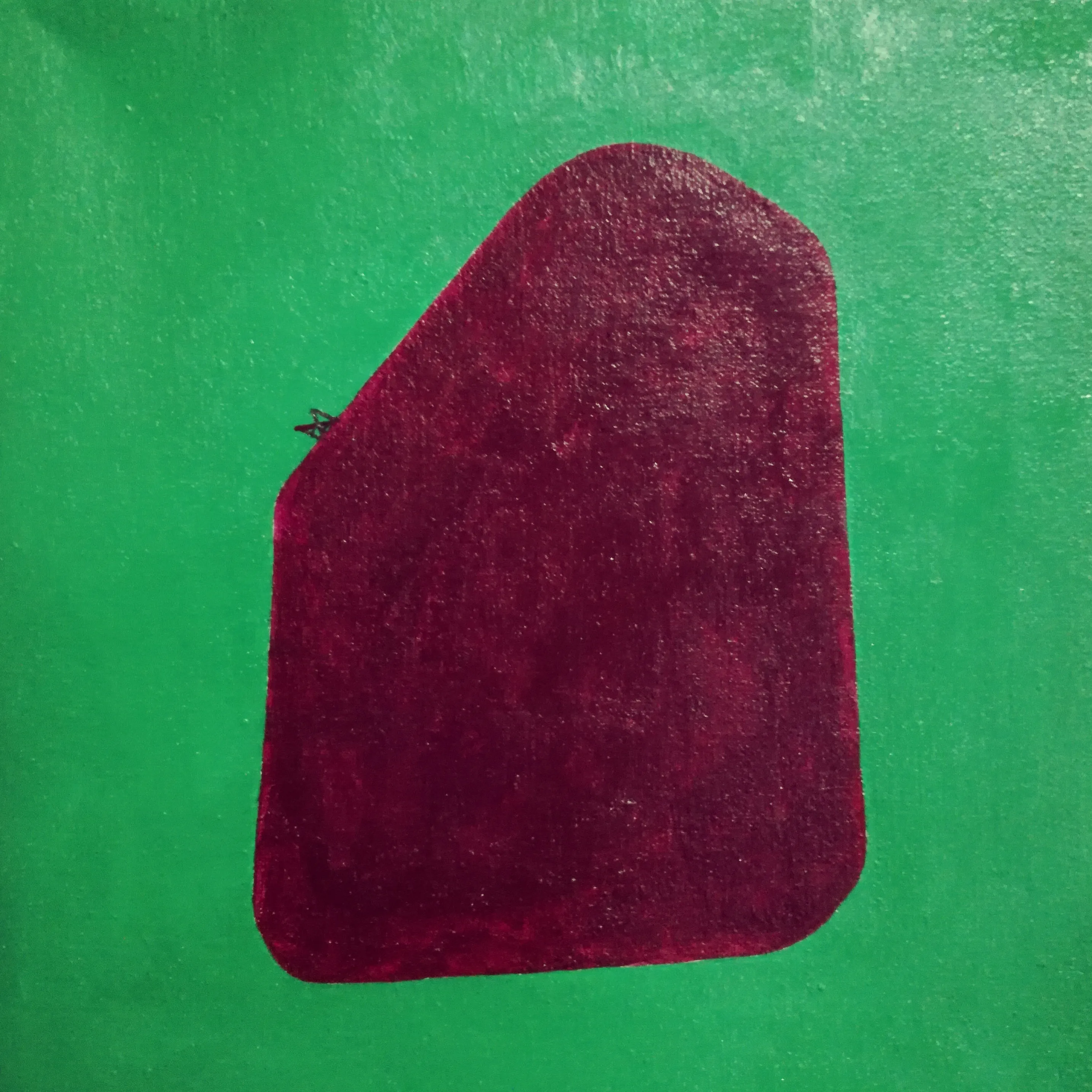 Painting of a maroon rounded stone on a flat green ground.
